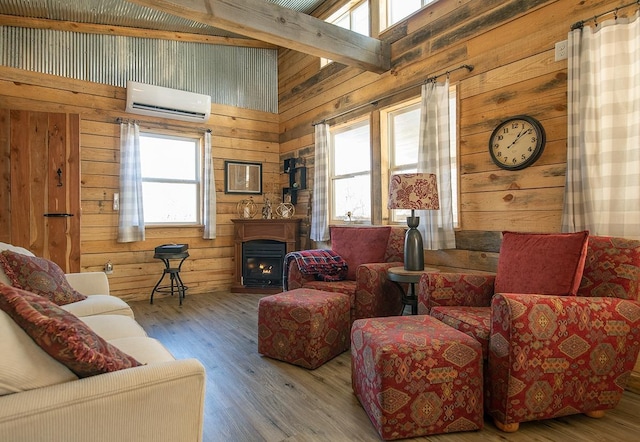 living room featuring hardwood / wood-style flooring, a wall mounted air conditioner, and wooden walls