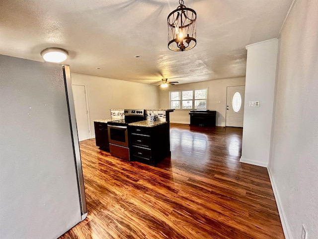 kitchen featuring stainless steel appliances, ceiling fan with notable chandelier, a textured ceiling, and dark hardwood / wood-style flooring