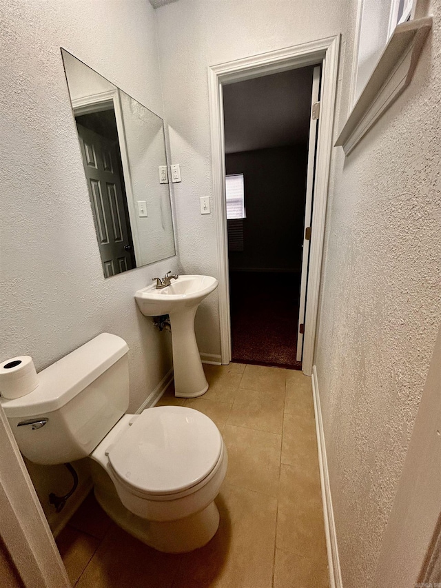 bathroom with sink, tile patterned floors, and toilet