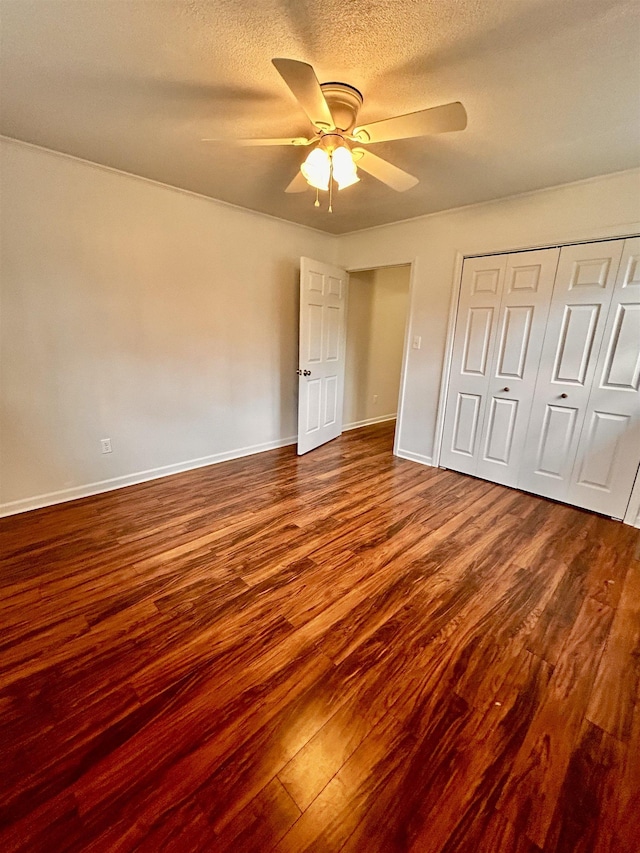 unfurnished bedroom featuring hardwood / wood-style flooring, ceiling fan, a closet, and a textured ceiling