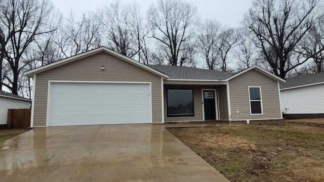 ranch-style house featuring a garage, concrete driveway, and a shingled roof