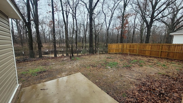 view of yard featuring fence and a patio