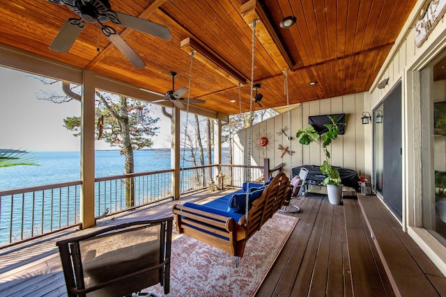 wooden deck featuring a water view and ceiling fan