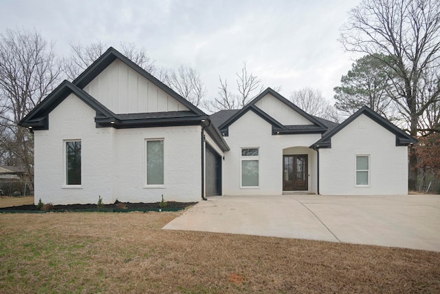 view of front facade featuring french doors and a front lawn