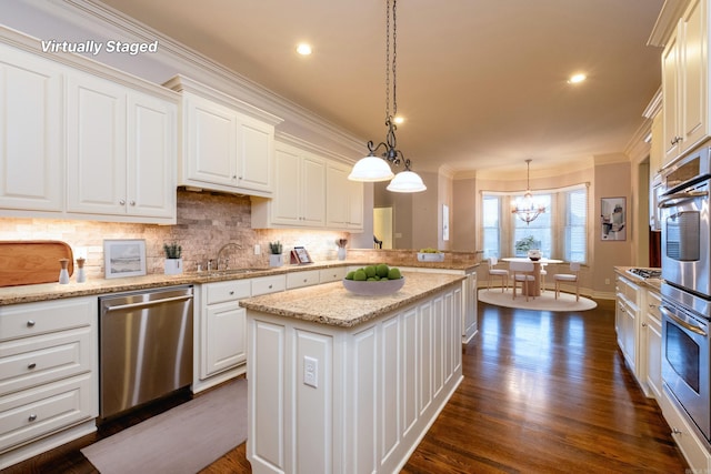 5 Deauville Cir, Little Rock, AR 72223 - kitchen featuring hanging light fixtures, stainless steel appliances, a center island, and white cabinets