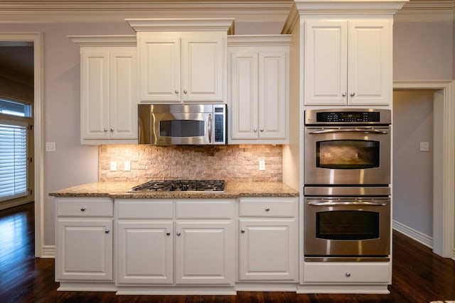 5 Deauville Cir, Little Rock, AR 72223 - kitchen with stainless steel appliances, dark hardwood / wood-style flooring, light stone countertops, and decorative backsplash