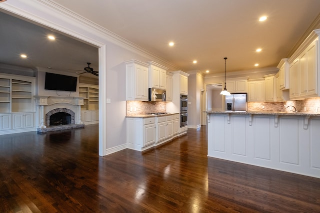 5 Deauville Cir, Little Rock, AR 72223 - kitchen with hanging light fixtures, white cabinetry, appliances with stainless steel finishes, and light stone counters