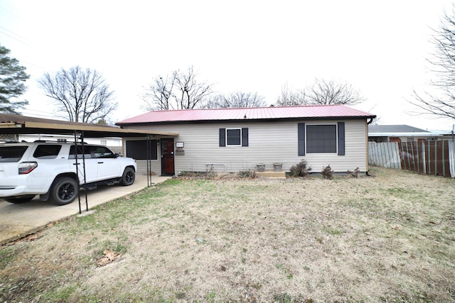 ranch-style home with a carport and a front yard