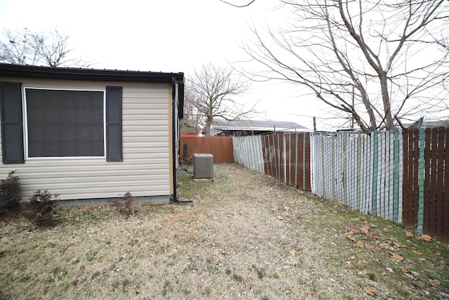 view of property exterior with central AC and a lawn