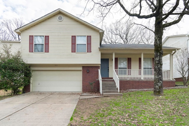 tri-level home featuring a garage and a porch