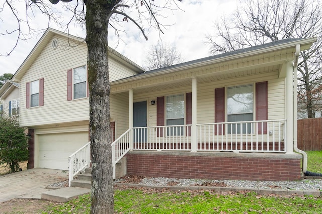 split level home featuring a garage and a porch