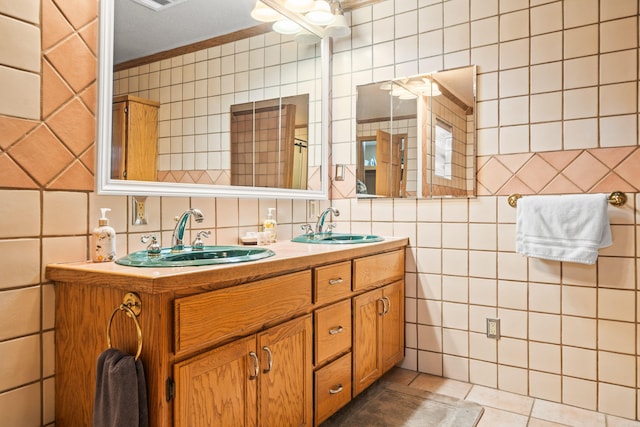 bathroom with tile walls, vanity, and tile patterned floors