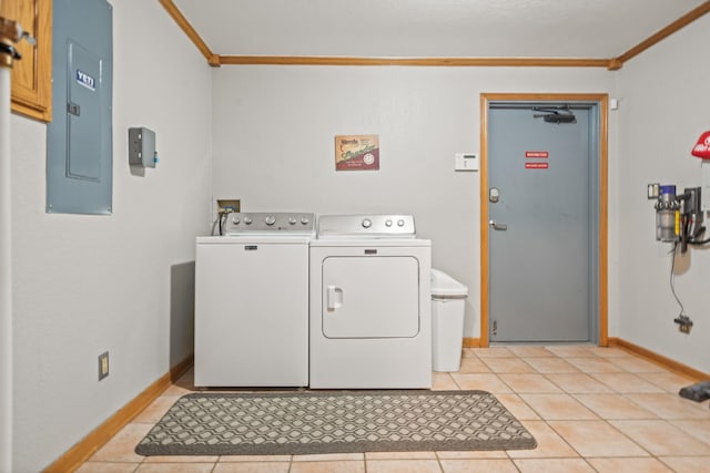 laundry area with light tile patterned flooring, washer and dryer, electric panel, and crown molding