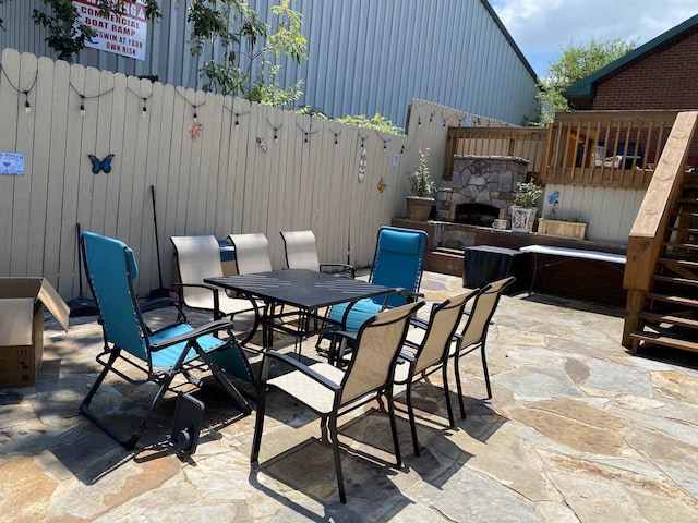 view of patio / terrace featuring an outdoor stone fireplace