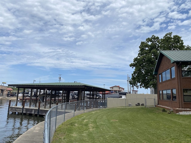 dock area with a yard and a water view