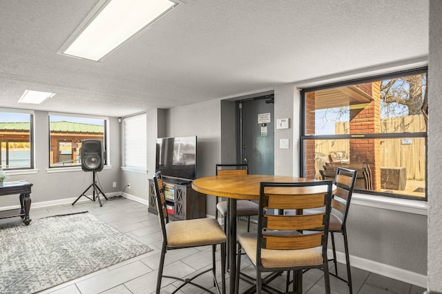 dining area featuring a textured ceiling