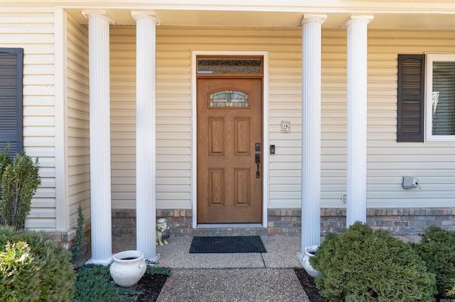 view of exterior entry with a porch