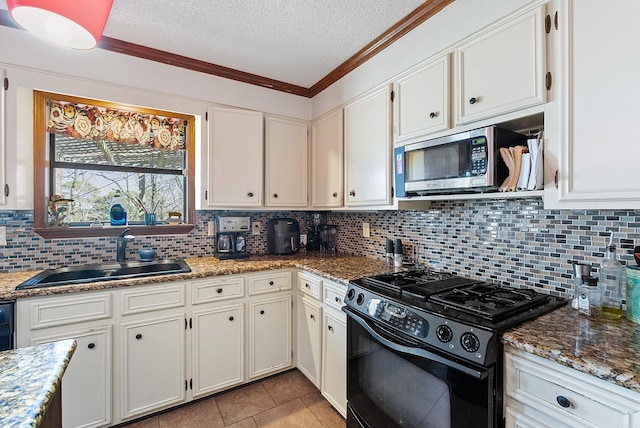 kitchen featuring white cabinetry, black range with gas stovetop, and sink