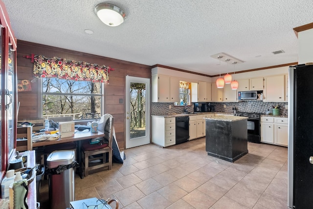 kitchen with sink, crown molding, a center island, decorative backsplash, and black appliances