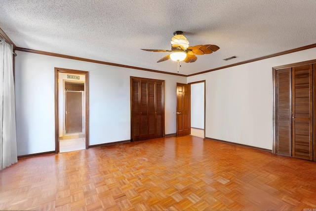 unfurnished bedroom with ceiling fan, light parquet flooring, ornamental molding, and a textured ceiling