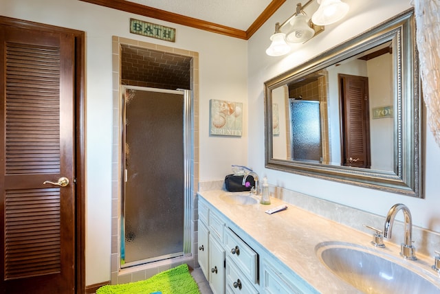 bathroom with crown molding, vanity, and a shower with shower door