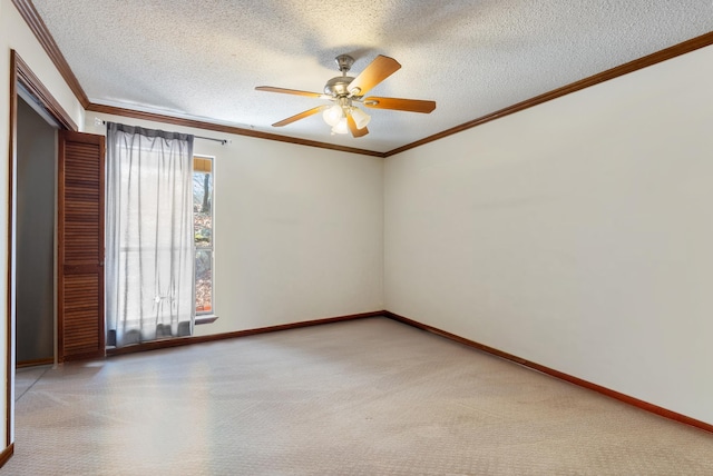 spare room featuring crown molding, light carpet, and a textured ceiling