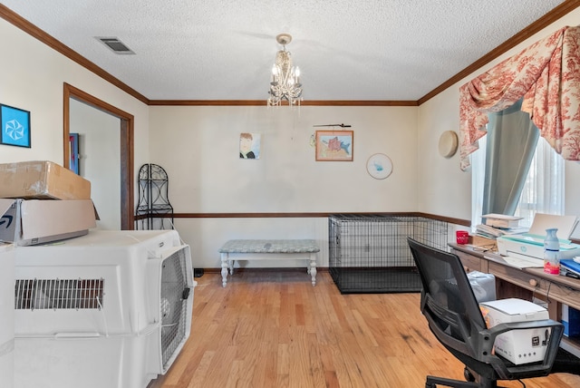 office featuring ornamental molding, a chandelier, a textured ceiling, and light hardwood / wood-style floors