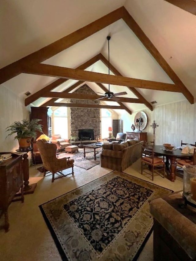 living room featuring vaulted ceiling with beams, a fireplace, and ceiling fan