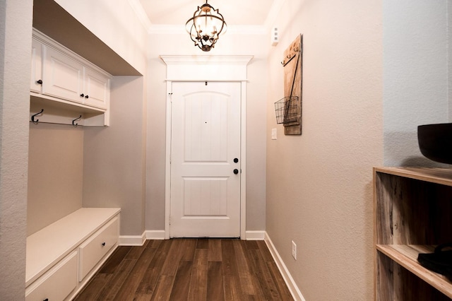 mudroom featuring dark hardwood / wood-style flooring, crown molding, and an inviting chandelier