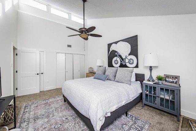 carpeted bedroom featuring ceiling fan and high vaulted ceiling