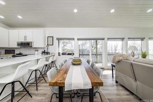 dining space with light hardwood / wood-style flooring and a wealth of natural light