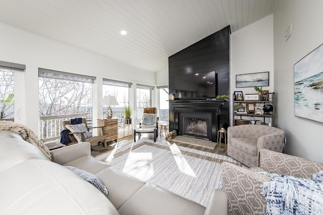 living room featuring high vaulted ceiling, a wealth of natural light, wood ceiling, and a fireplace