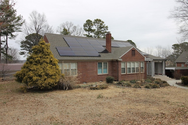 view of side of property featuring solar panels