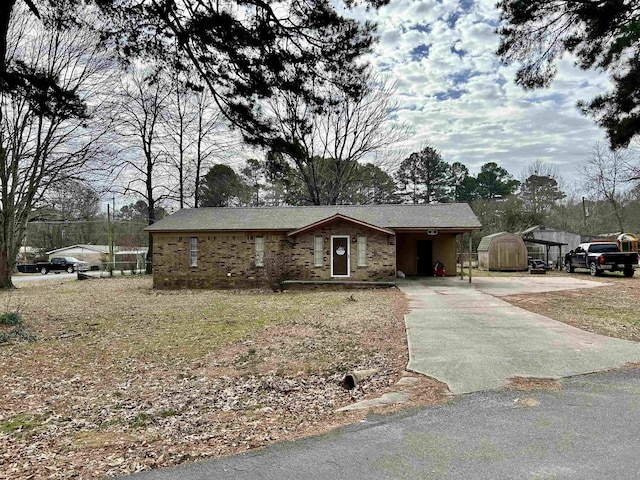 single story home featuring a storage shed