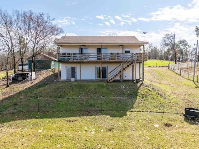 back of property featuring a yard and a deck