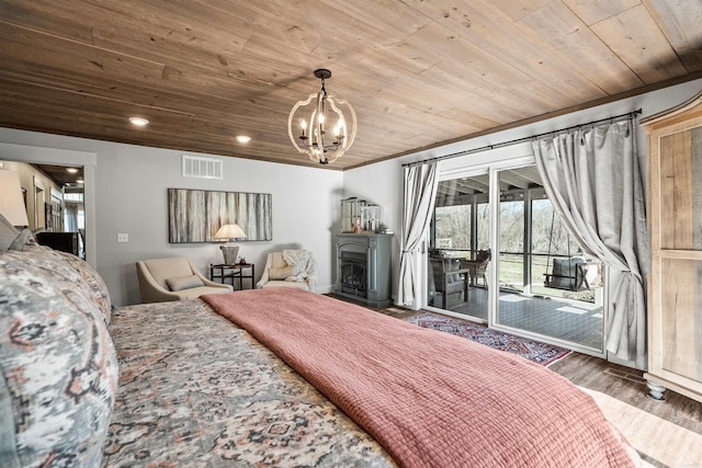 bedroom featuring hardwood / wood-style flooring, a notable chandelier, access to exterior, and wooden ceiling