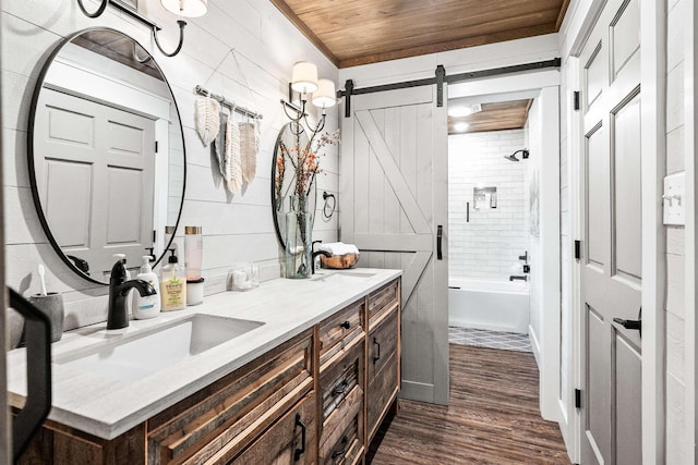 bathroom with vanity, hardwood / wood-style floors, wooden ceiling, and tiled shower / bath