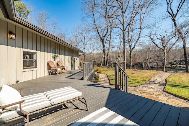 deck featuring a water view and a yard