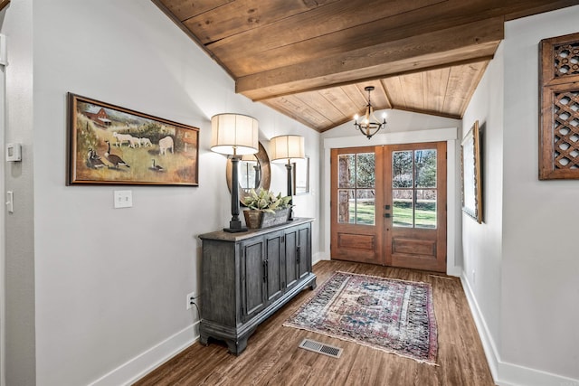 foyer featuring a chandelier, vaulted ceiling with beams, dark wood-type flooring, and wood ceiling