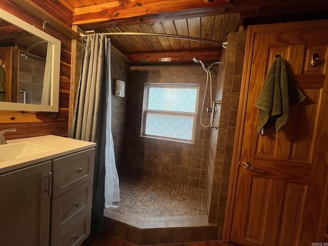 bathroom featuring wooden ceiling, beamed ceiling, vanity, and a shower stall