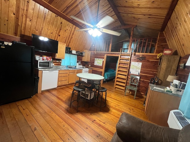 kitchen with light wood-style flooring, light countertops, freestanding refrigerator, dishwasher, and stainless steel microwave