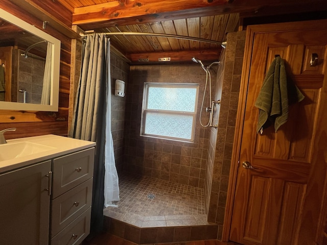 full bathroom with a stall shower, wooden ceiling, vanity, and beam ceiling