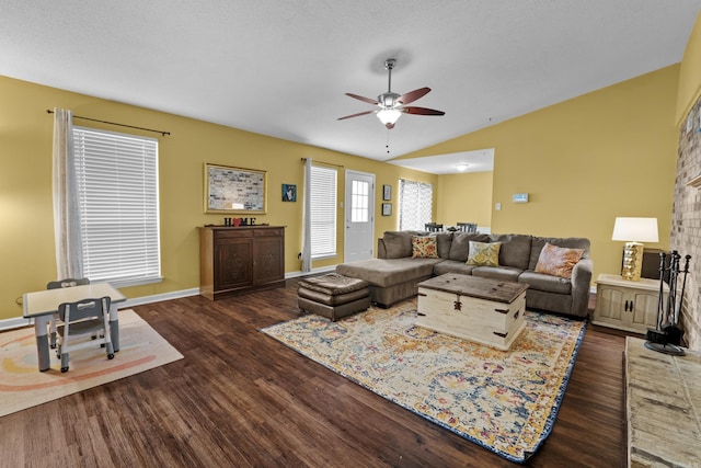 living room featuring ceiling fan, lofted ceiling, and dark hardwood / wood-style flooring