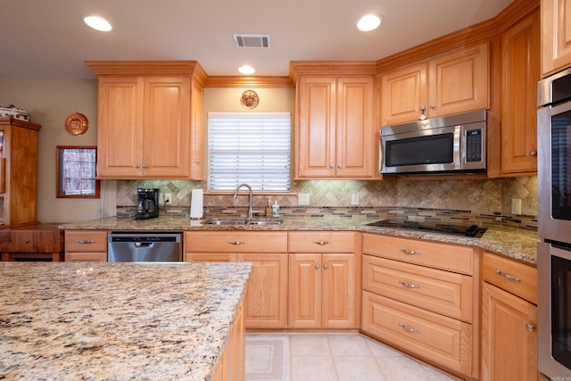 kitchen featuring sink, light tile patterned floors, stainless steel appliances, light stone countertops, and decorative backsplash