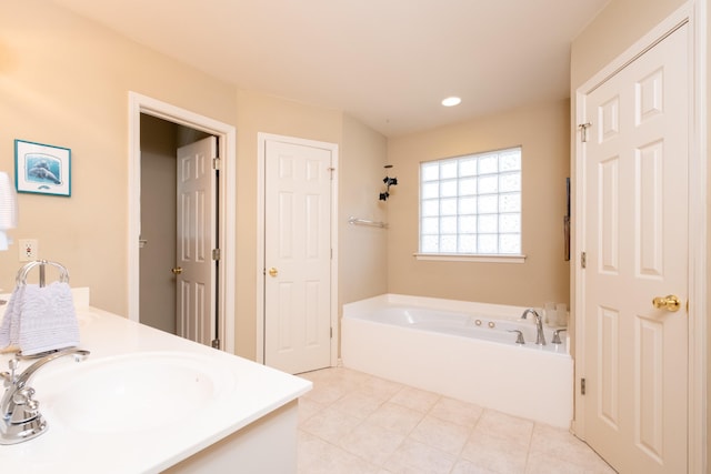 bathroom with vanity, a washtub, and tile patterned floors