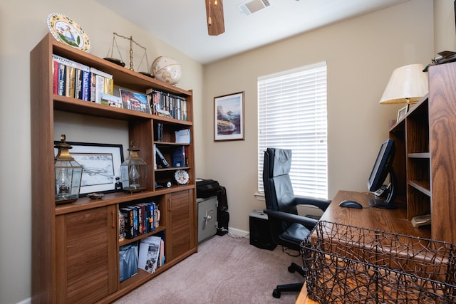 carpeted home office featuring ceiling fan