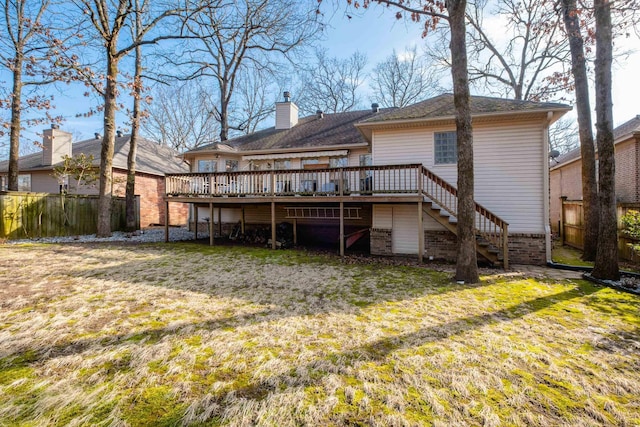 rear view of house featuring a yard and a deck