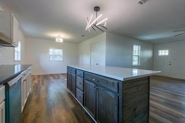 kitchen with white cabinetry, a center island, hanging light fixtures, dark hardwood / wood-style flooring, and dishwasher