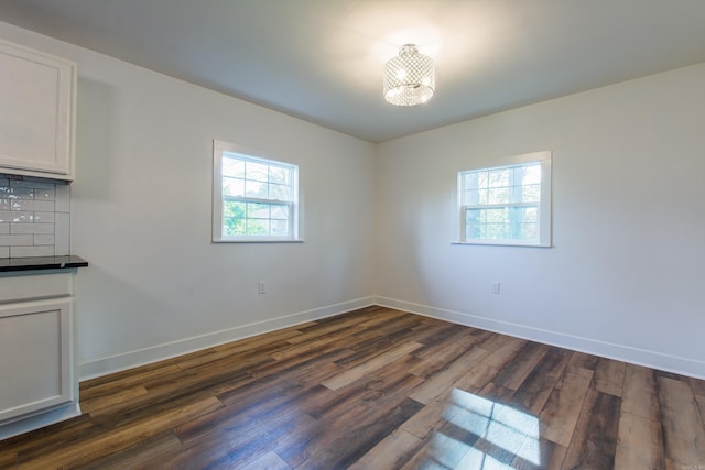 spare room with dark hardwood / wood-style flooring