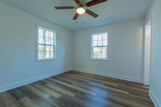 spare room featuring a wealth of natural light and dark hardwood / wood-style flooring